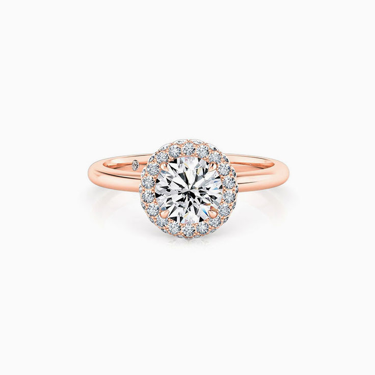 Round brilliant cut diamond with a 3d halo engagement ring