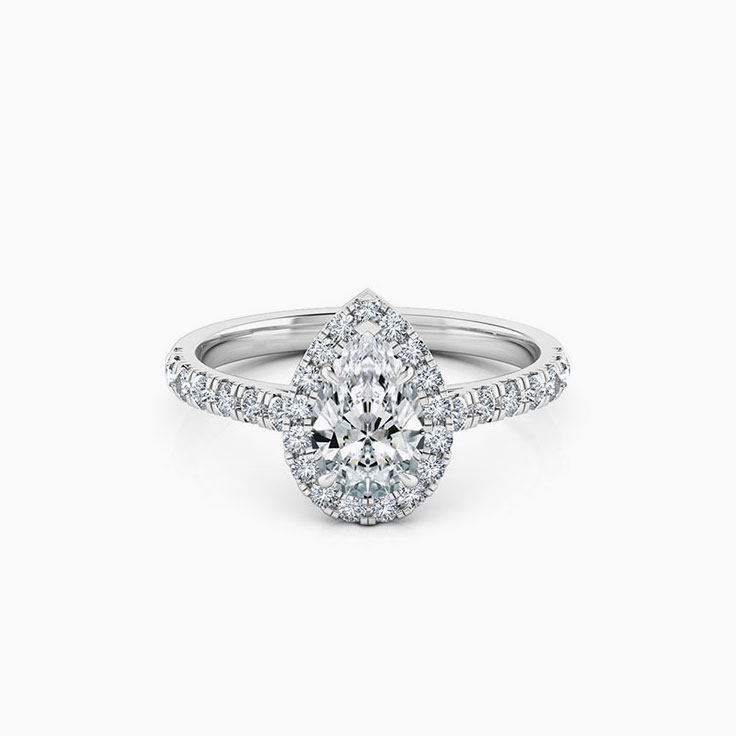 Pear cut diamond engagement ring with halo and diamond band