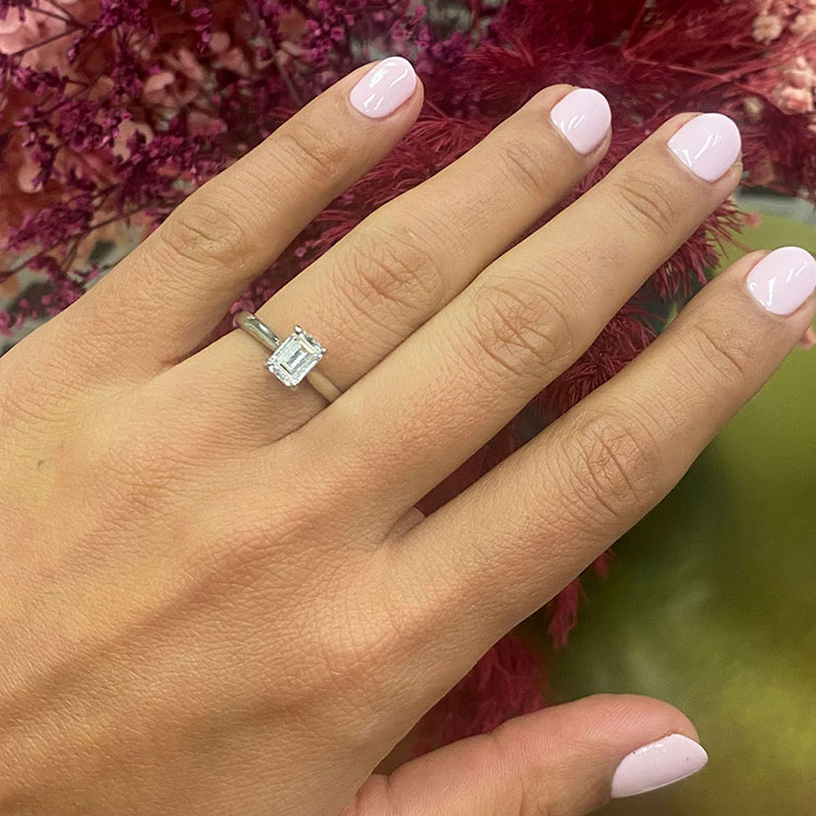 Emerald solitaire Engagement ring on a plain band