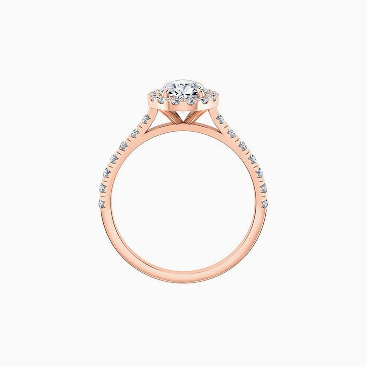 Pear cut diamond engagement ring with halo and diamond band